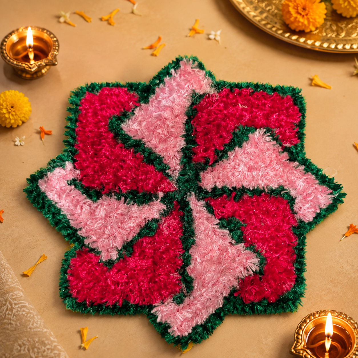 Pink floral handmade festive mat styled with diyas and marigold flowers
