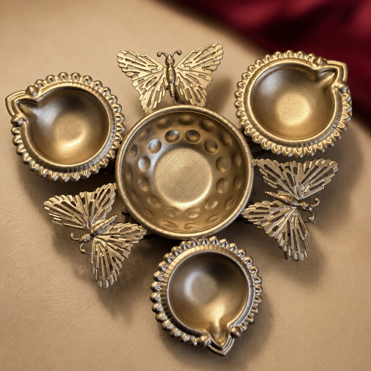 Close-up of the actual butterfly three-diya holder showing openwork accents and its true finish