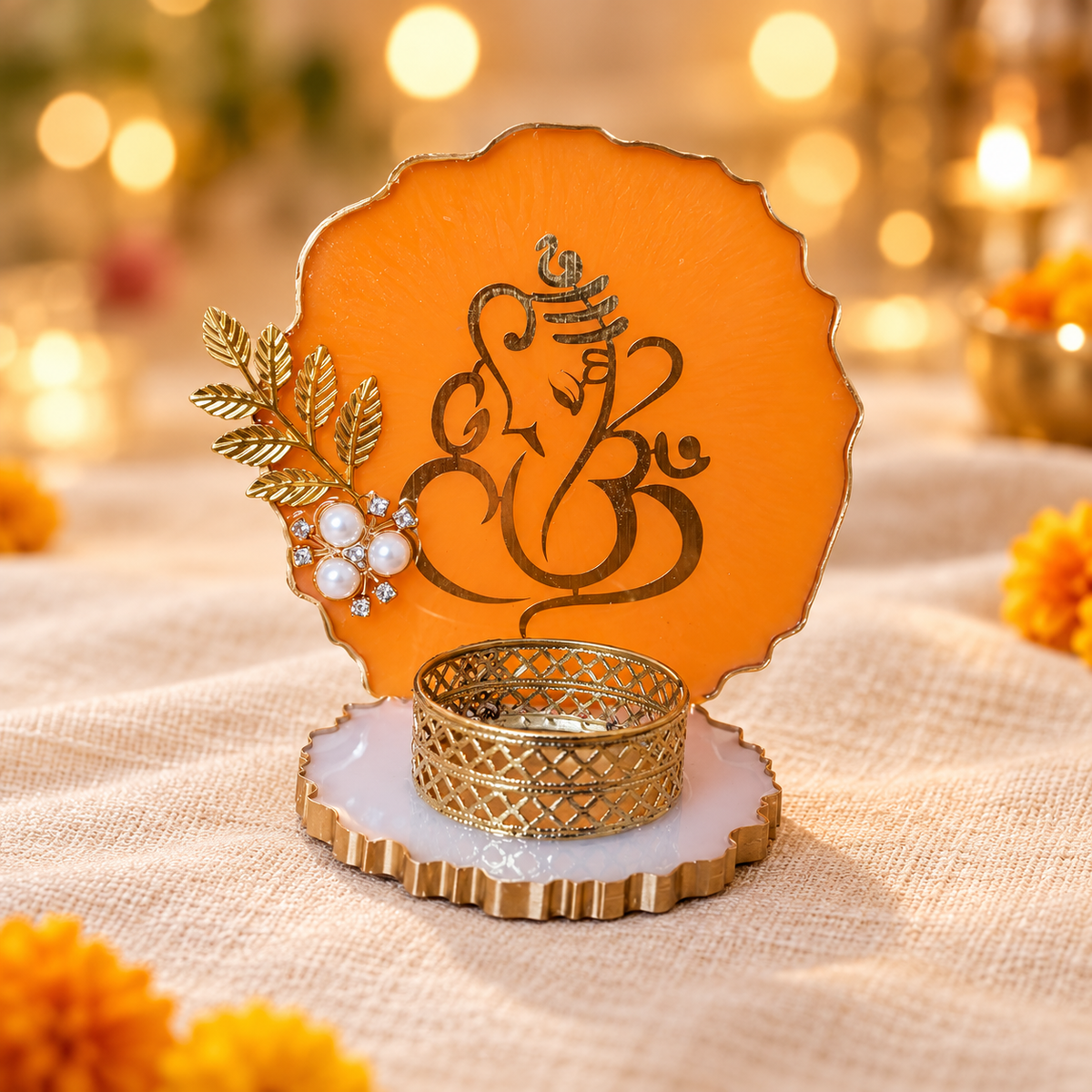 Orange Ganesha resin tealight holder with gold-tone artwork and pearl accents