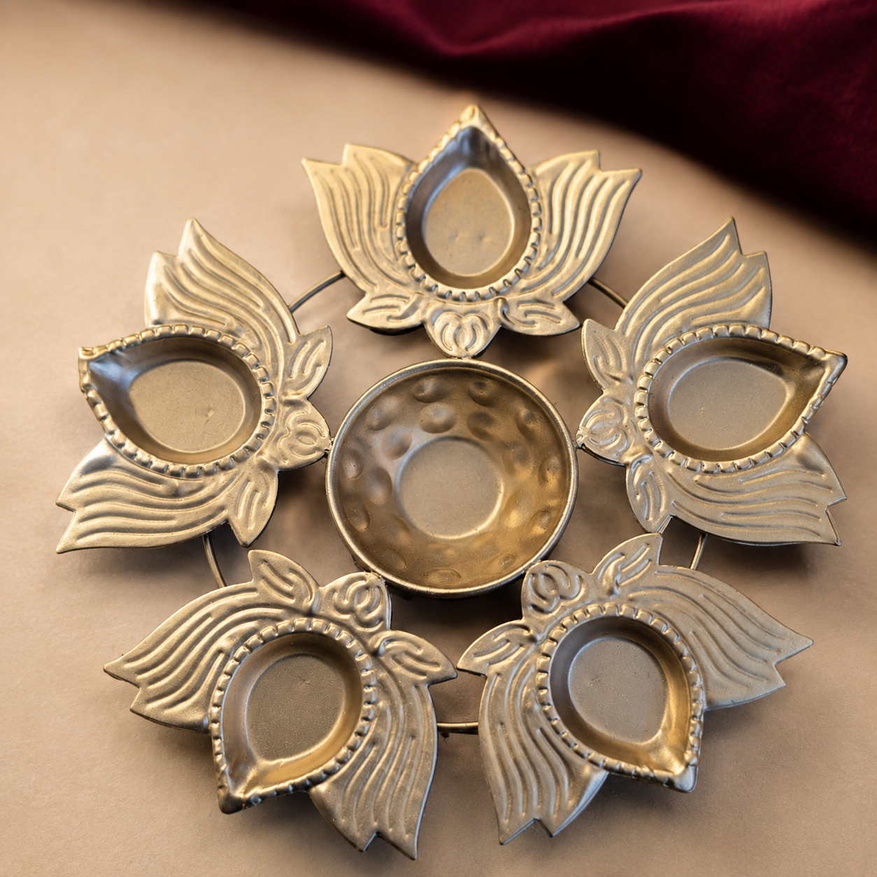 Close-up of the actual lotus five-diya holder showing petal details and its true finish