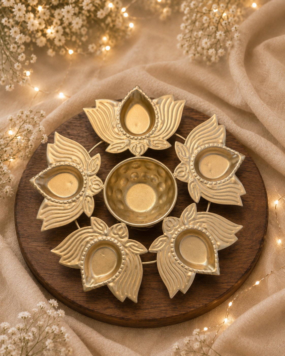 Lotus five-diya tealight holder styled with warm festive lights on a wooden board