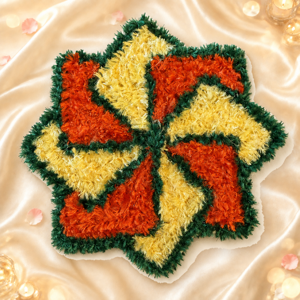 Orange yellow and green handmade pinwheel mat on bright champagne silk with festive glow