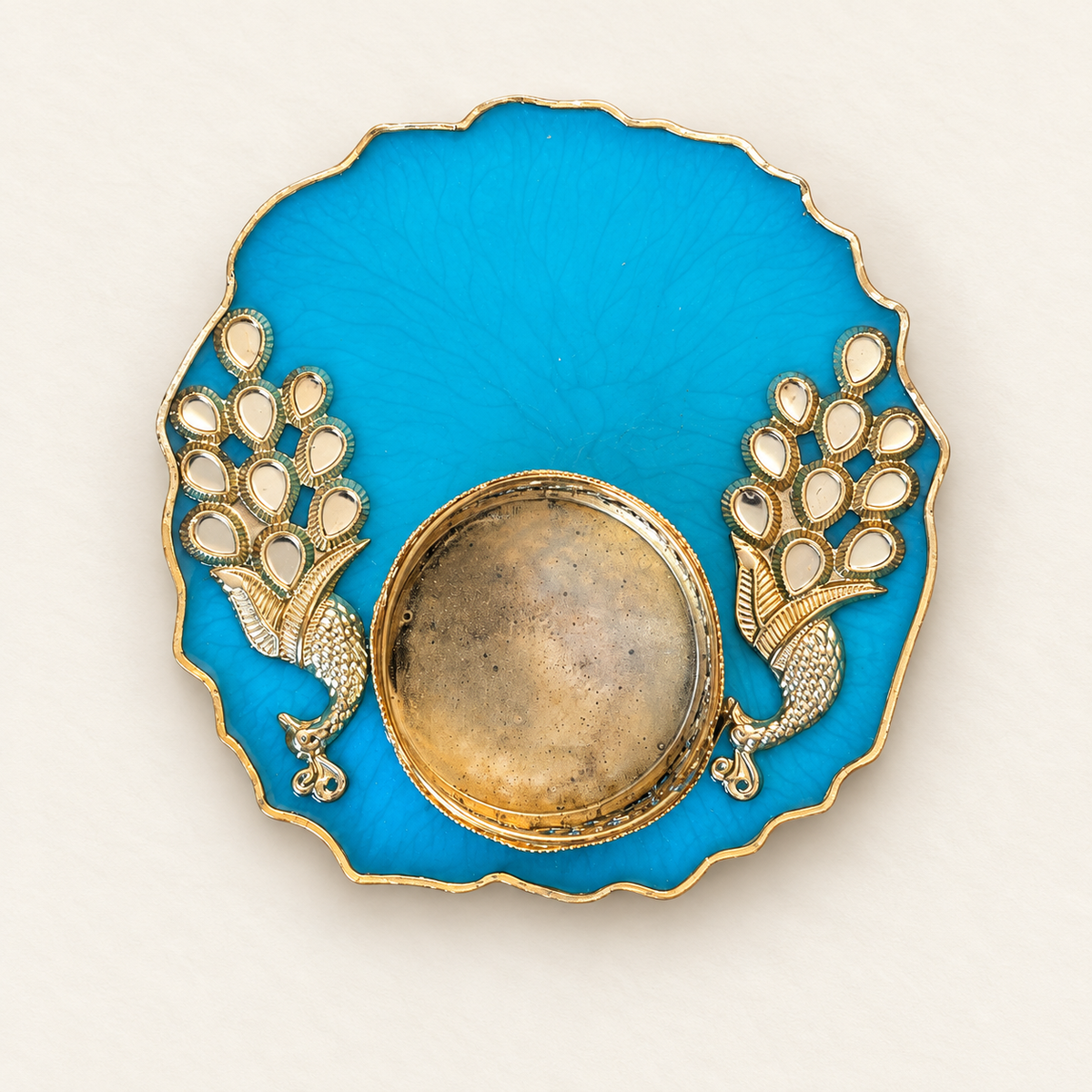 Peacock-blue resin tealight holder with two gold-tone peacock embellishments and scalloped edge
