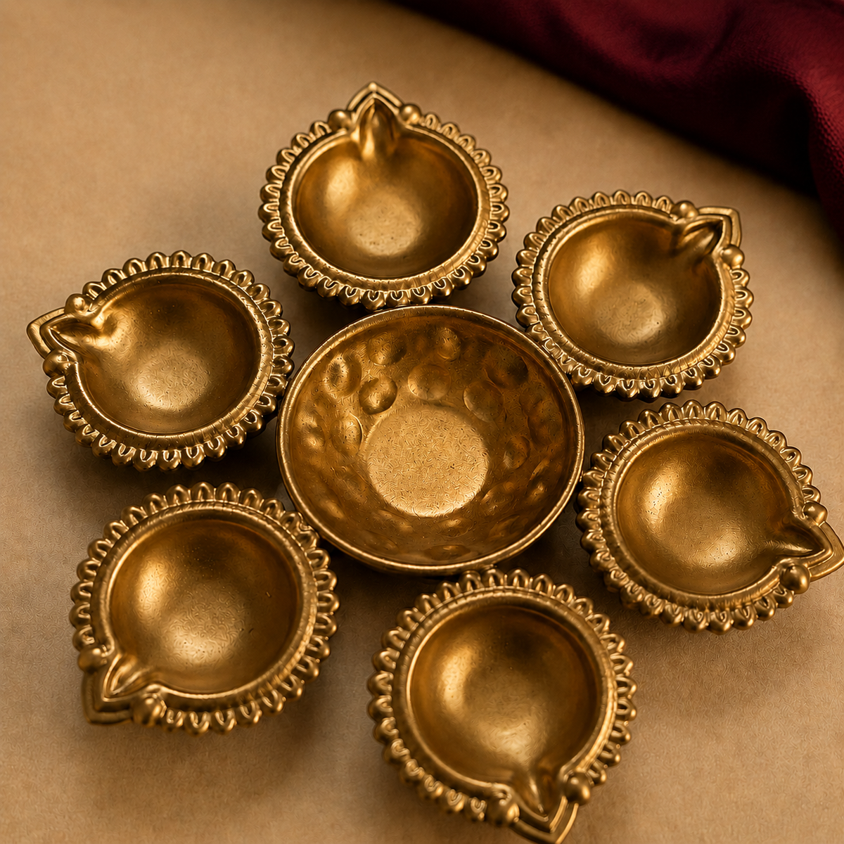 Close-up of the actual six-diya round holder showing scalloped cups, embossed center and its true brass tone