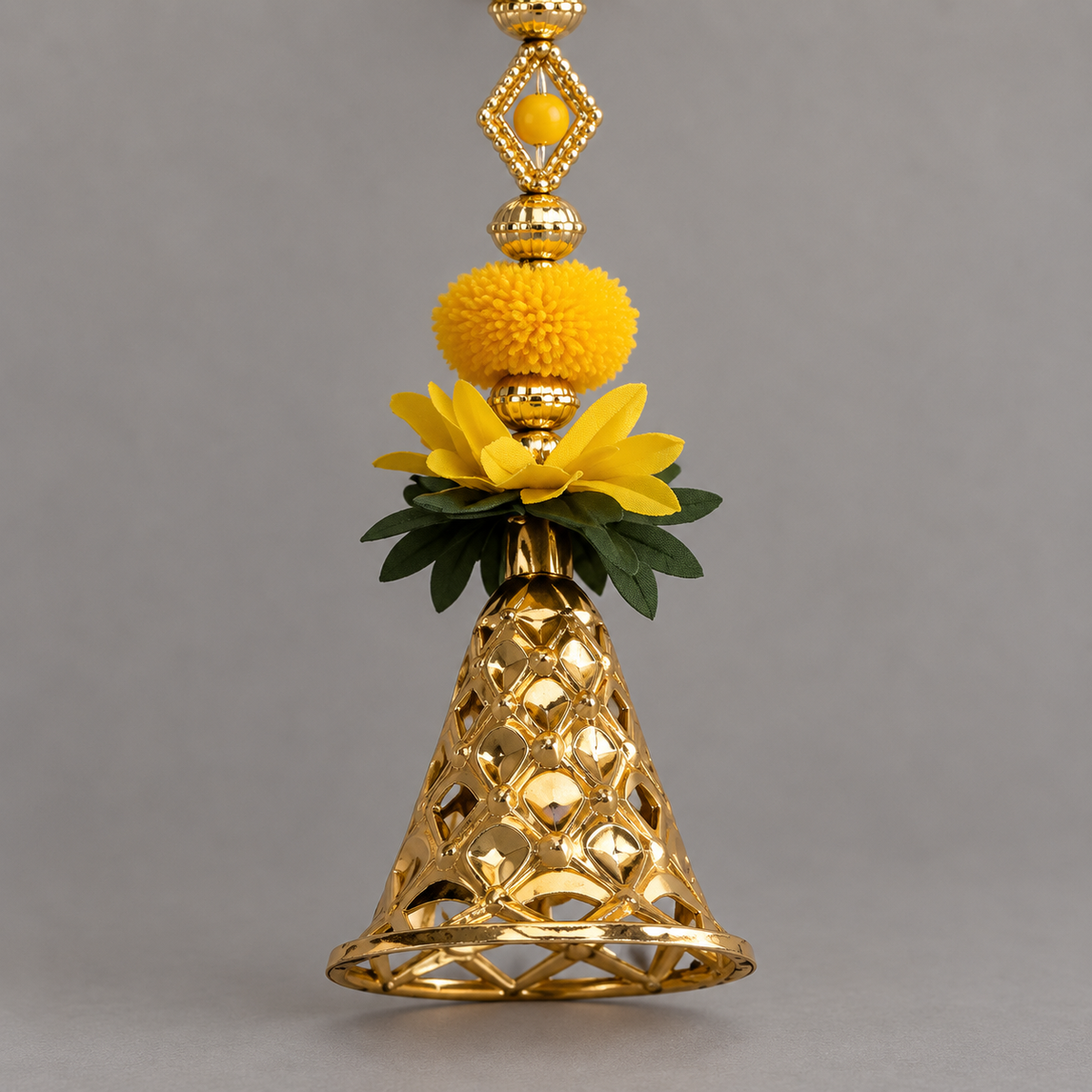 Close-up of the yellow hanging's flared gold-tone openwork bell